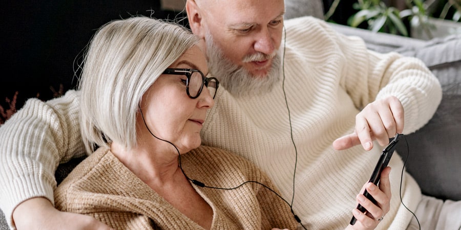 elderly couple listening to music