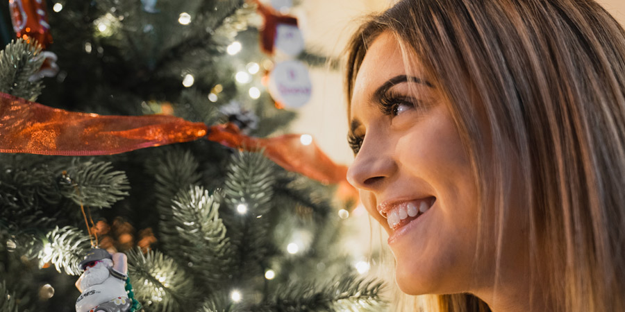 woman looking at christmas tree