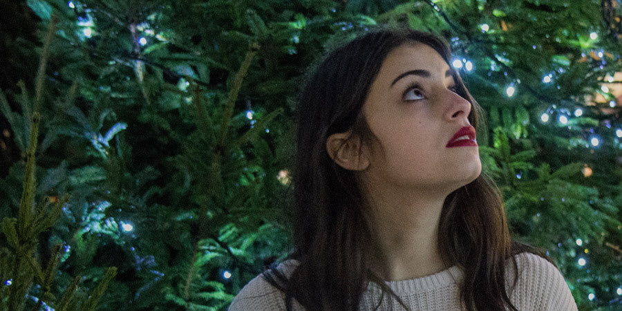 woman looking at christmas trees