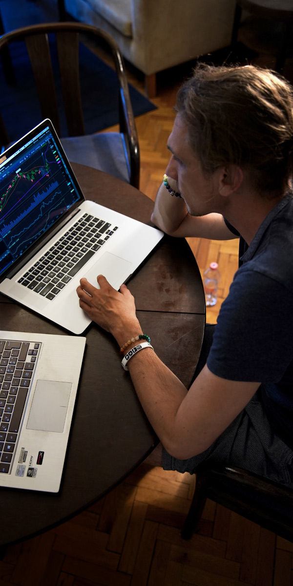 man using two laptops