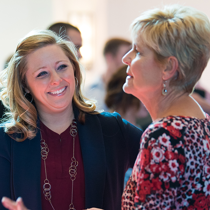women talking in church
