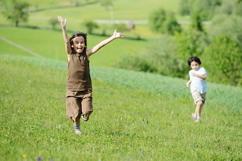 children running through field