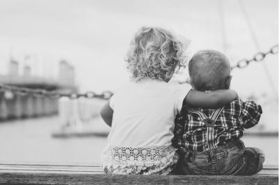 toddler hugging baby