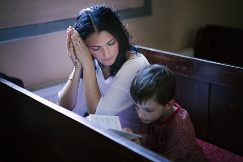 mother and son praying