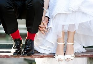 man and woman dressed up holding hands