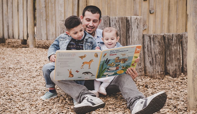 dad reading book to children