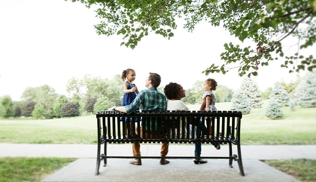 family sitting on bench