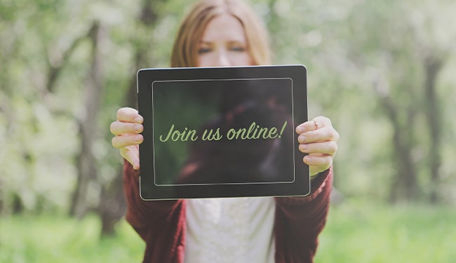 woman holding join us online sign