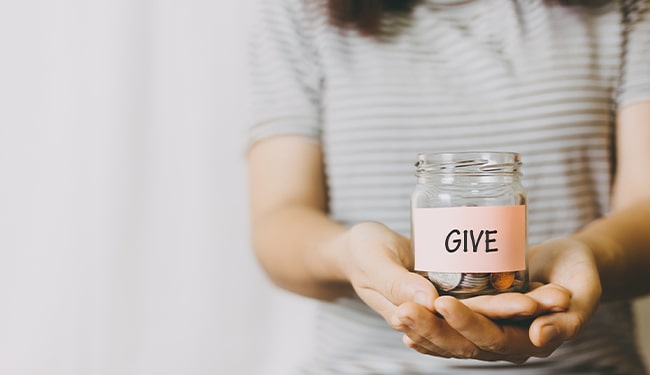 woman holding give jar