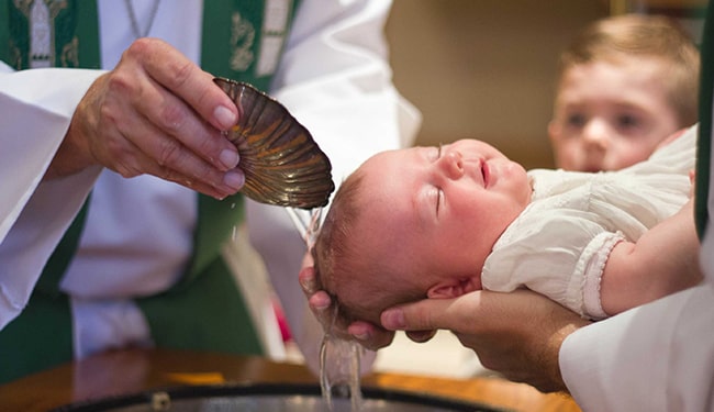 priest christening baby