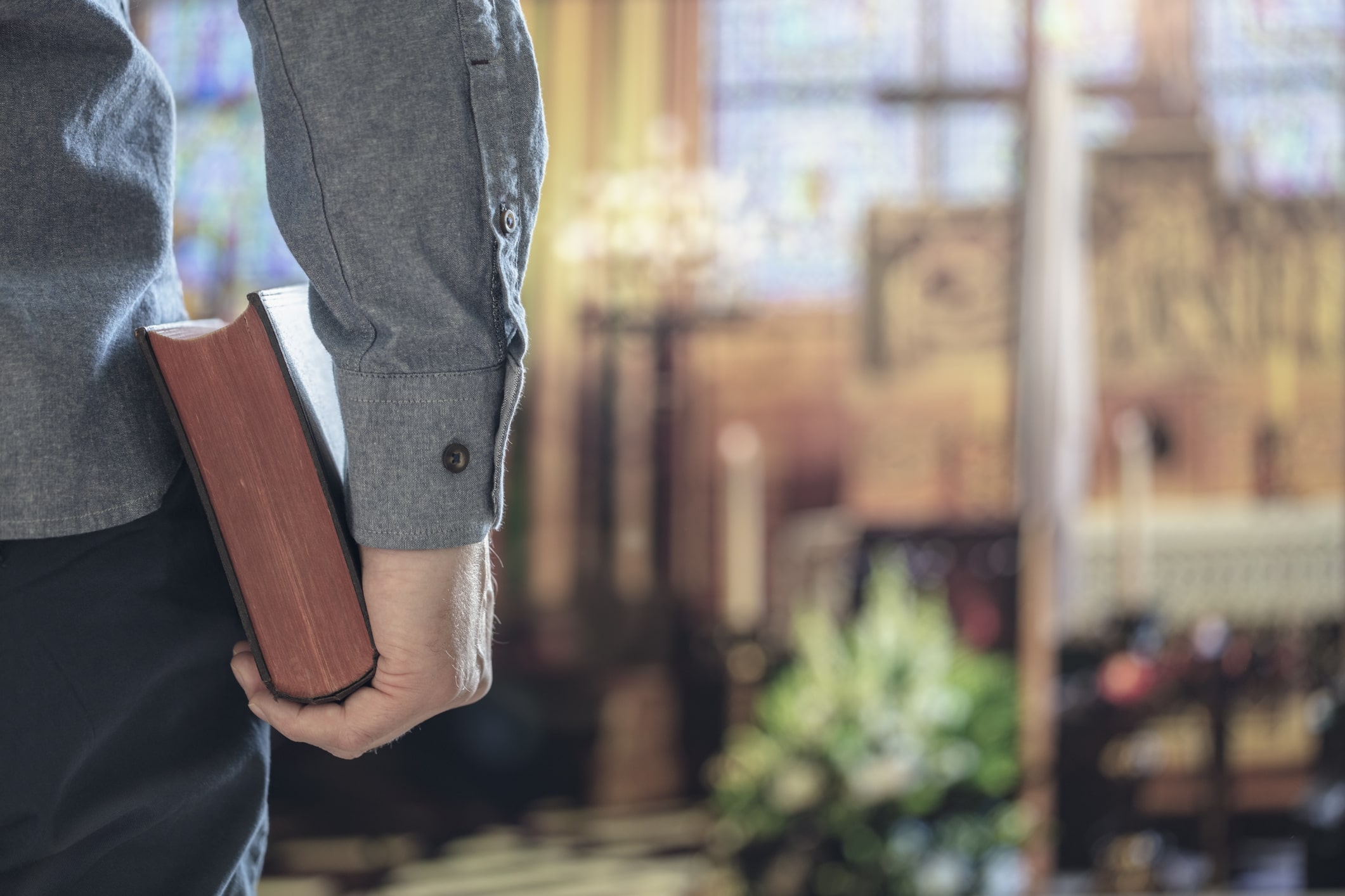 man holding bible in church