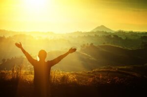 spiritual person enjoying sunlight in nature