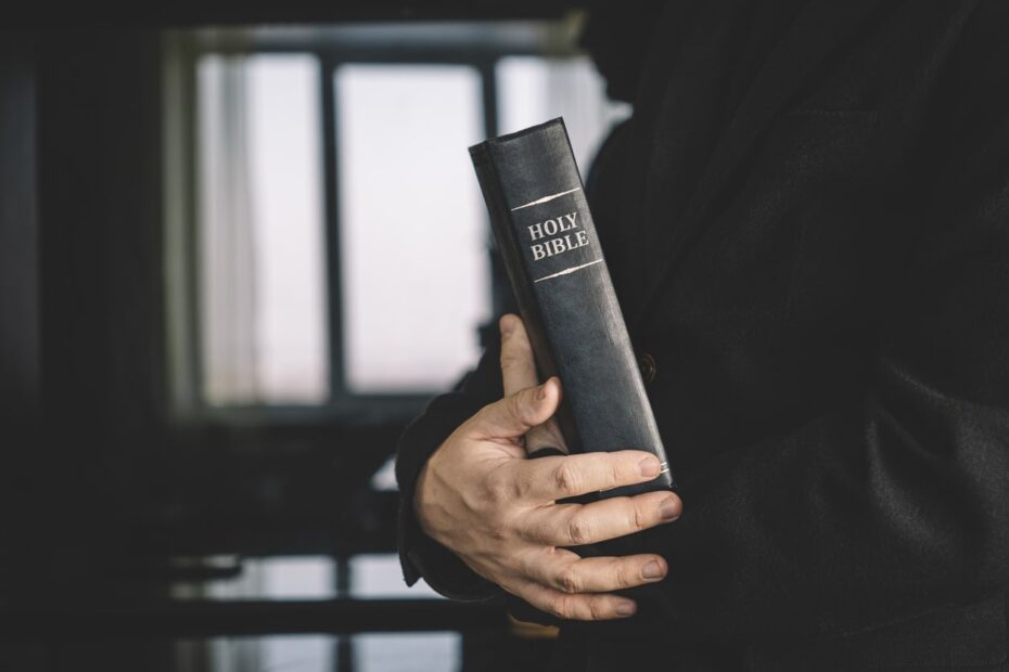 pastor holding a black bible