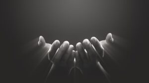 black and white image of hands reaching out