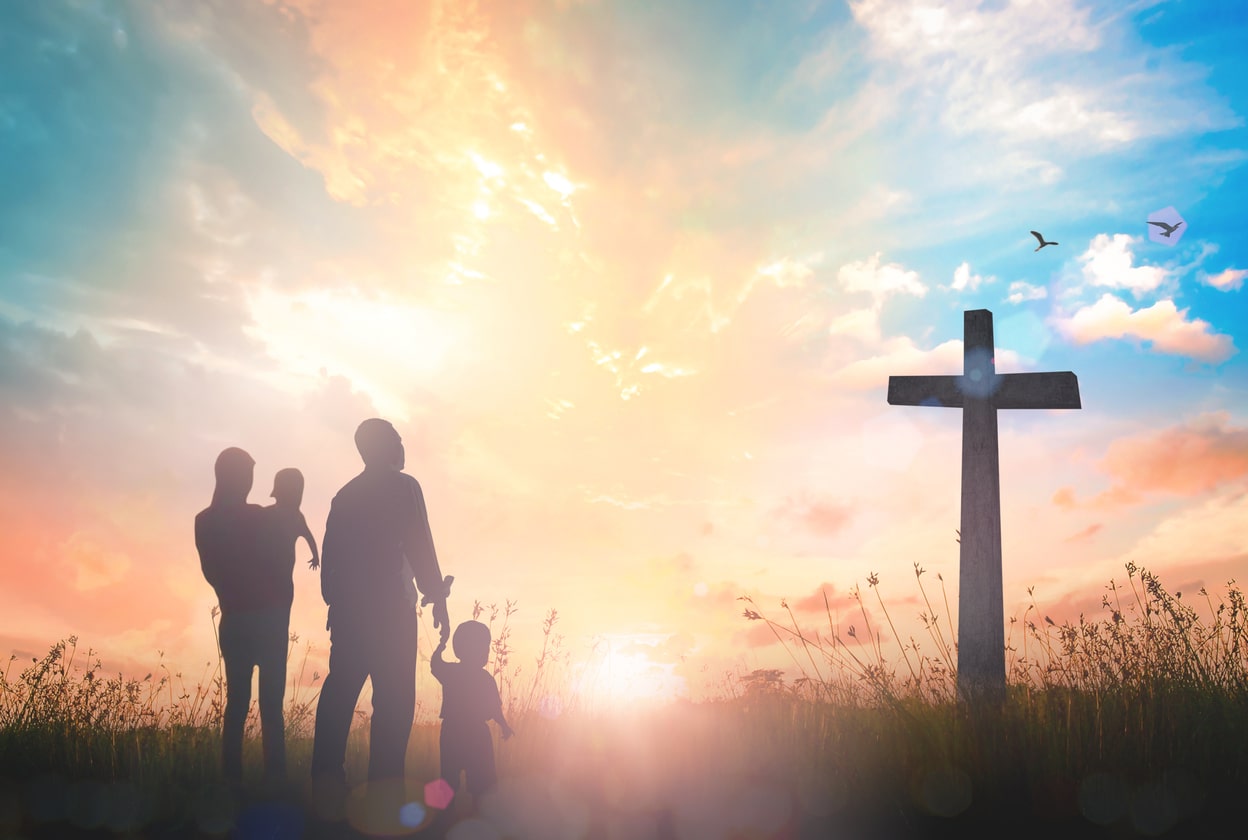 family looking up at cross