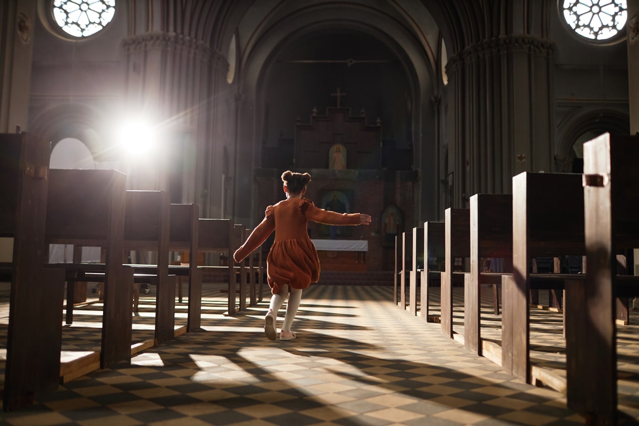 little girl walking inside of a church