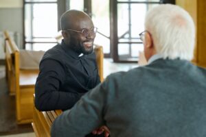 preacher talking to elderly man