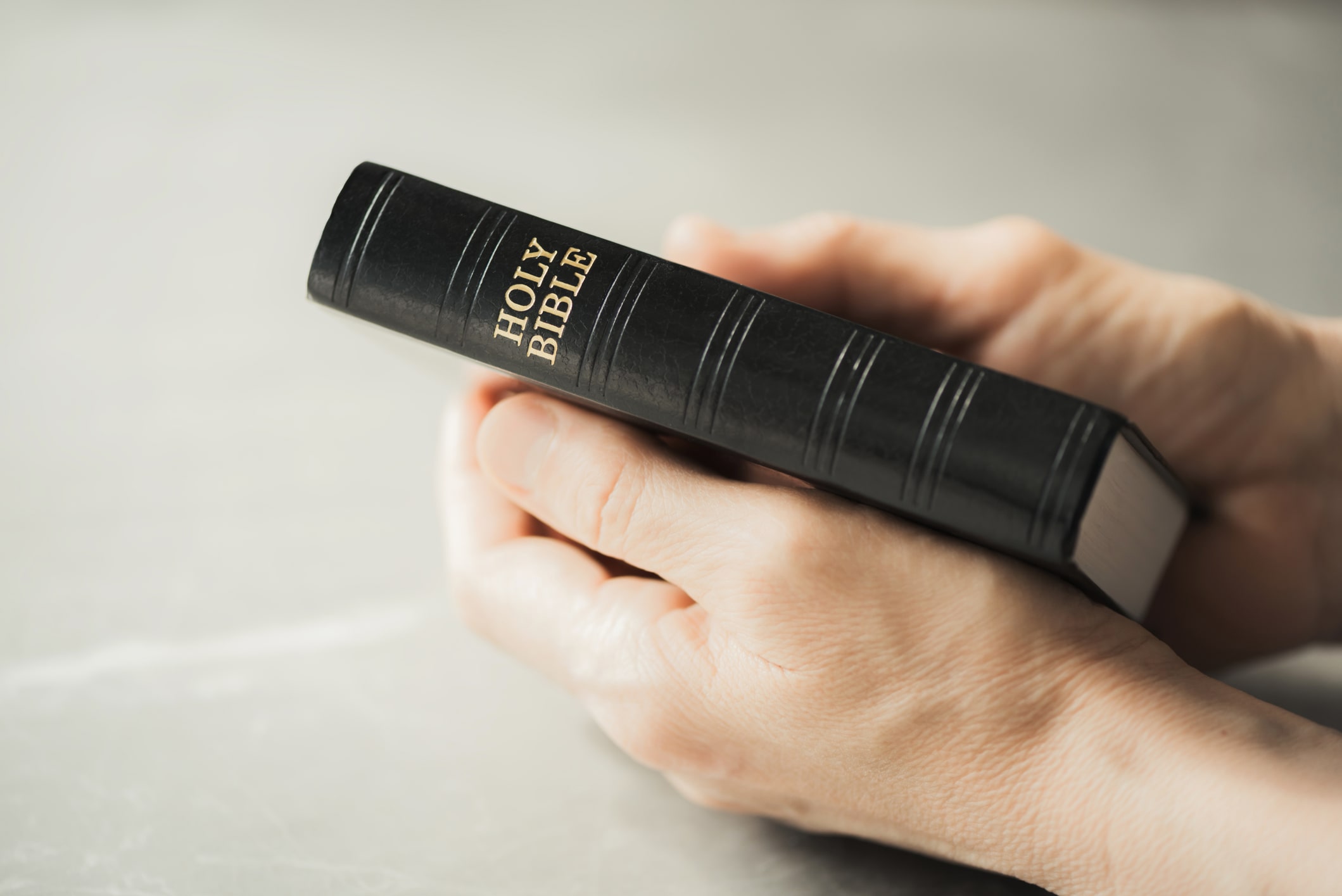 person holding a closed bible