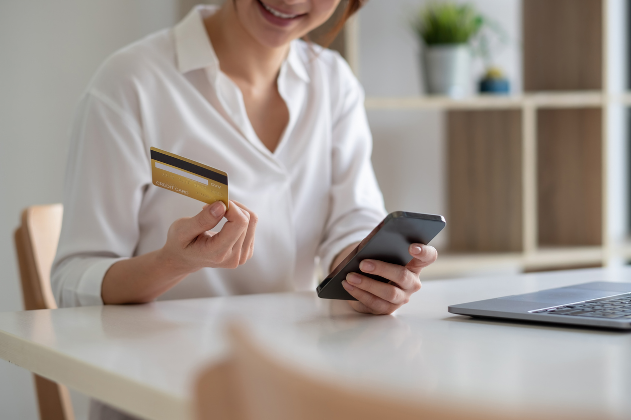 A woman on her phone using online giving for her church