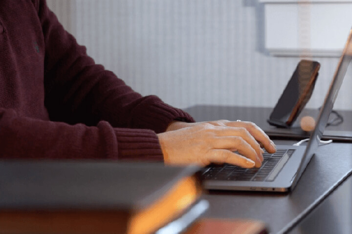 woman typing on laptop