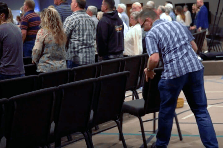 man setting chairs