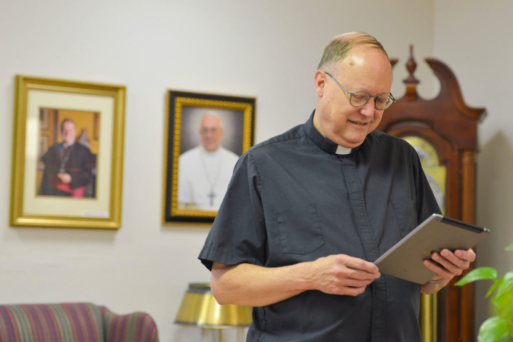 Priest with iPad
